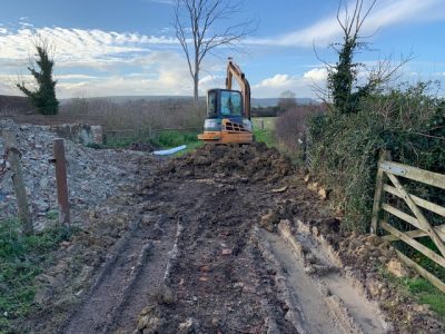  soil and rubble from the pond being stacked.