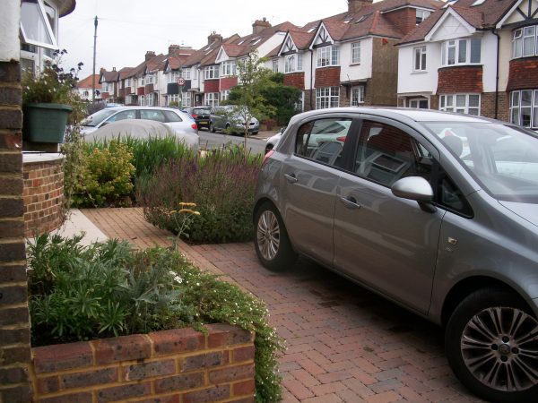 A small front garden with parking