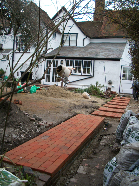 The stepping stone brick path and solid path section leading from the back door to the gate.