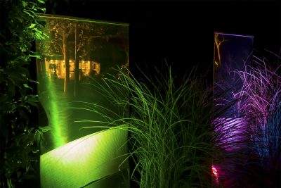 Garden sculptures lit with coloured lights