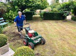 An airrating machine, being used on a lawn.