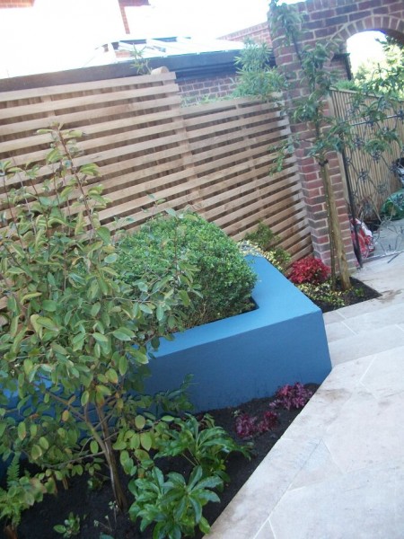 Blues and oranges in a chic modern courtyard garden in Brighton