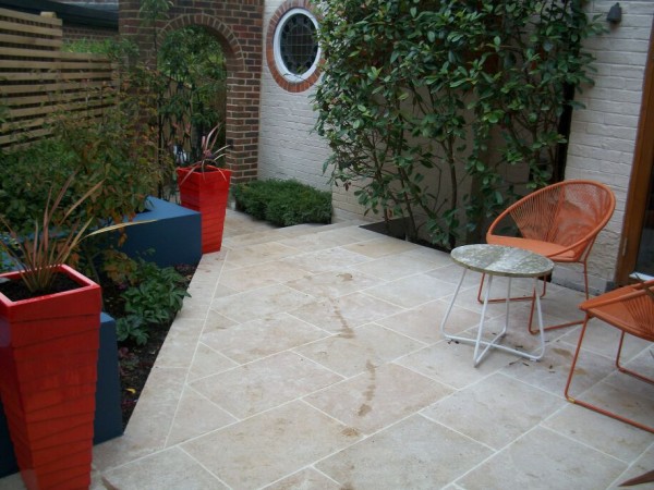 brillent oranges and elegant landscaping with a sawn stone terrace Brighton