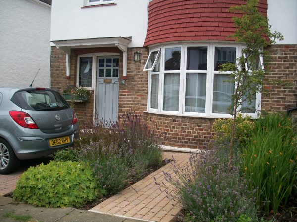 A small front garden with parking