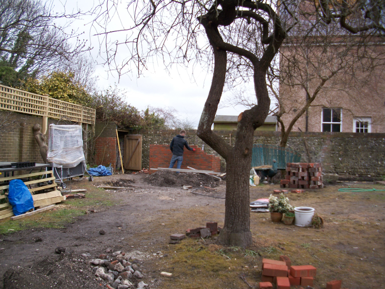 Trellis panels are being erected on the back boundary wall to add privacy from neighbouring offices. 
